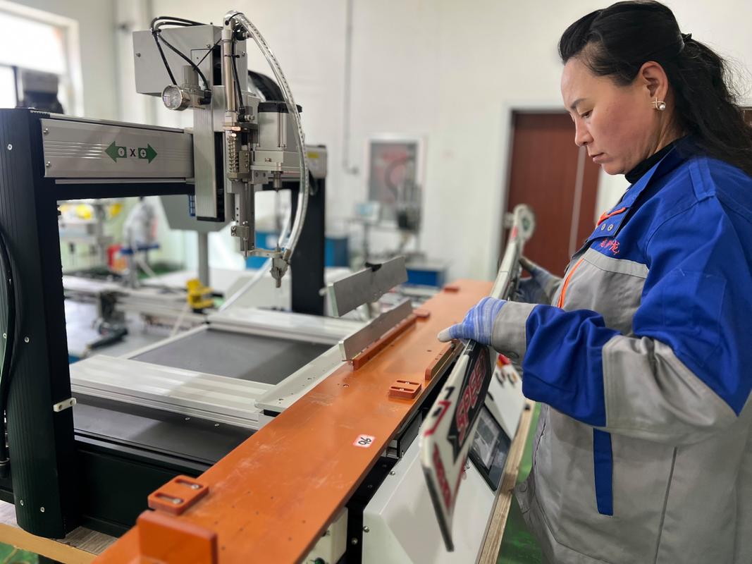 工业质检员用放大镜检查金属零件表面